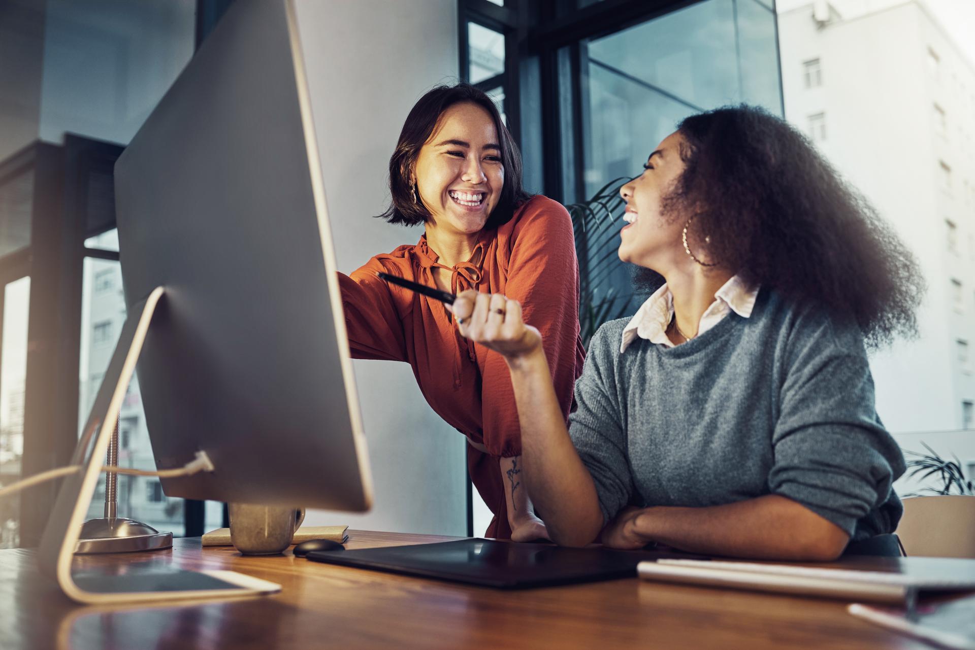 Collaboration, computer and business women in the office while working on a corporate project together. Teamwork, technology and professional female employees planning a company report in workplace.